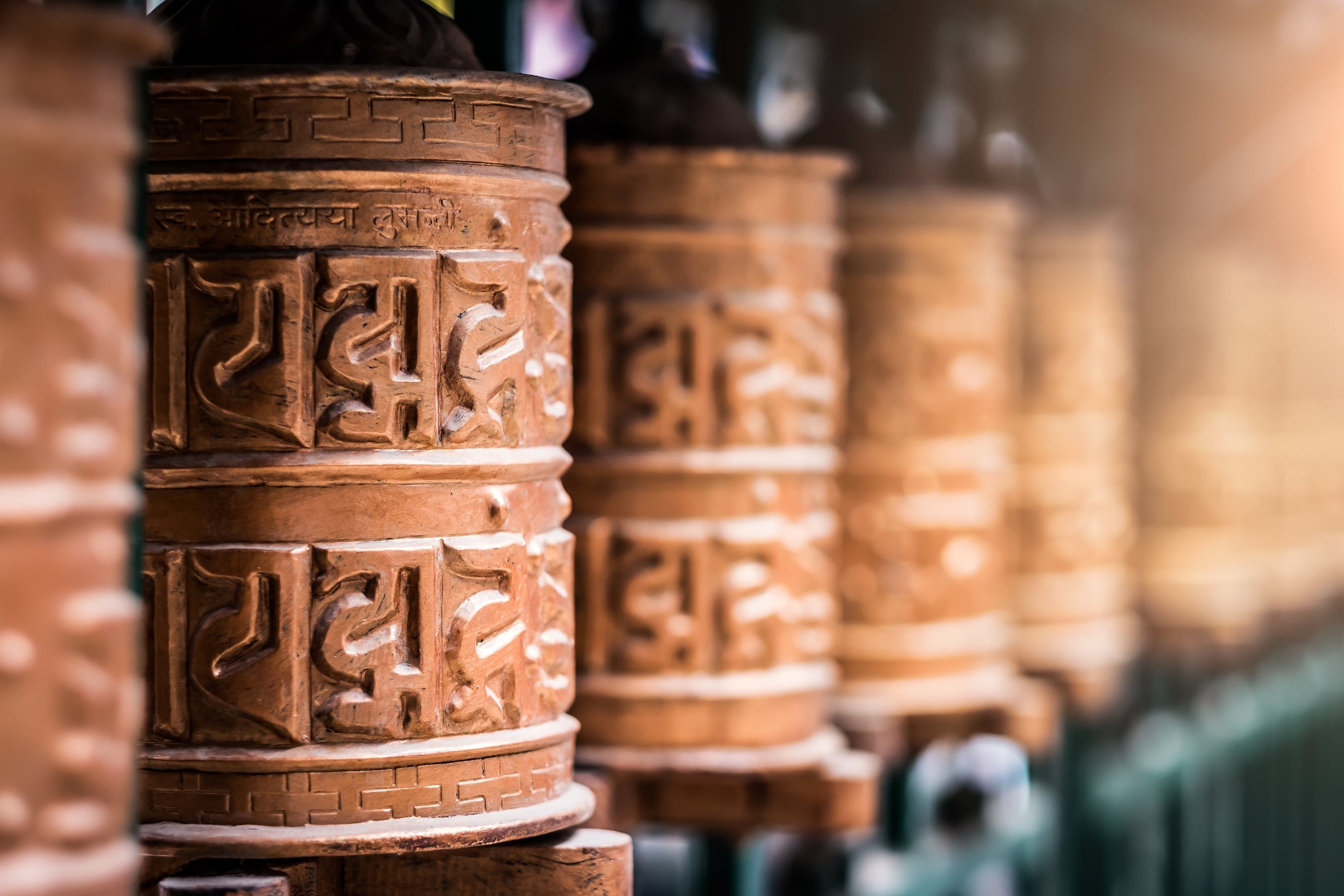 Traditional Nepalese prayer wheels embodying the ancient craft tradition behind Serene Streams Tibetan singing bowls