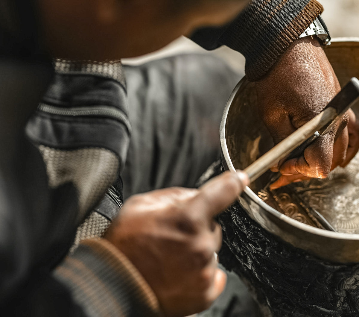 Kathmandu master artisan hand-hammering a Tibetan singing bowl in Nepal, Serene Streams heritage craft