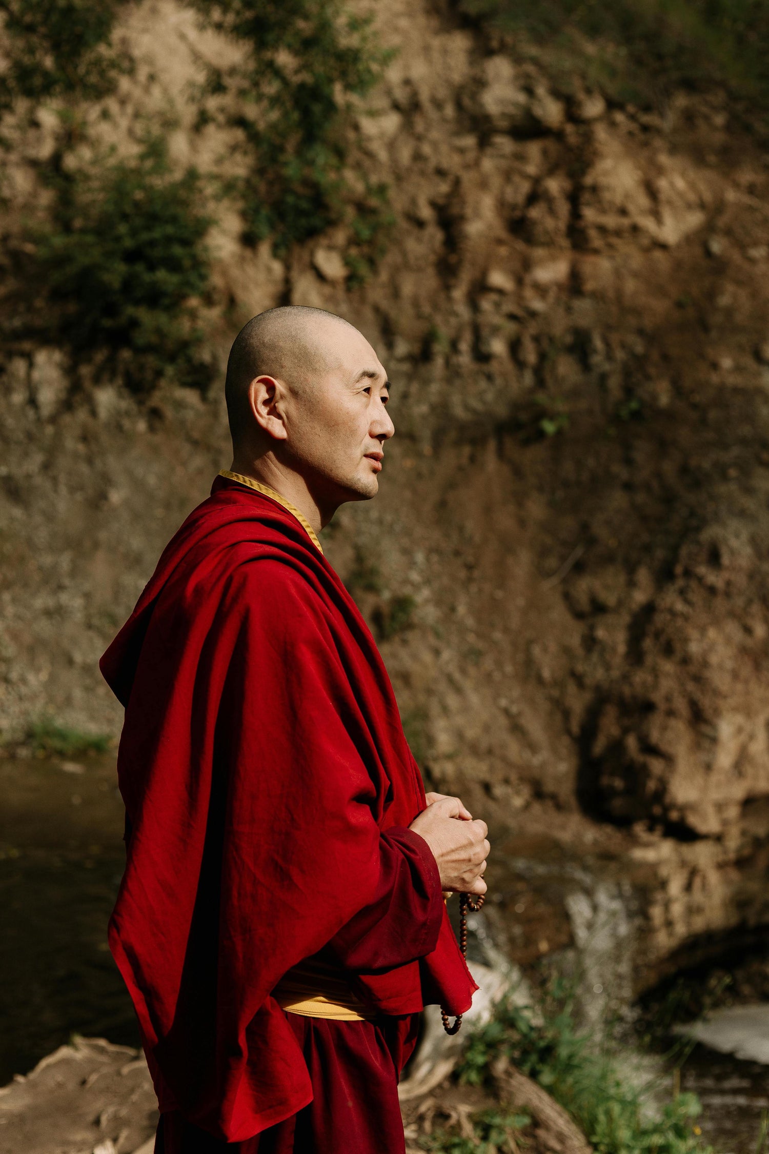Monk in a natural setting carrying the centuries-old craft tradition behind every Serene Streams Tibetan singing bowl