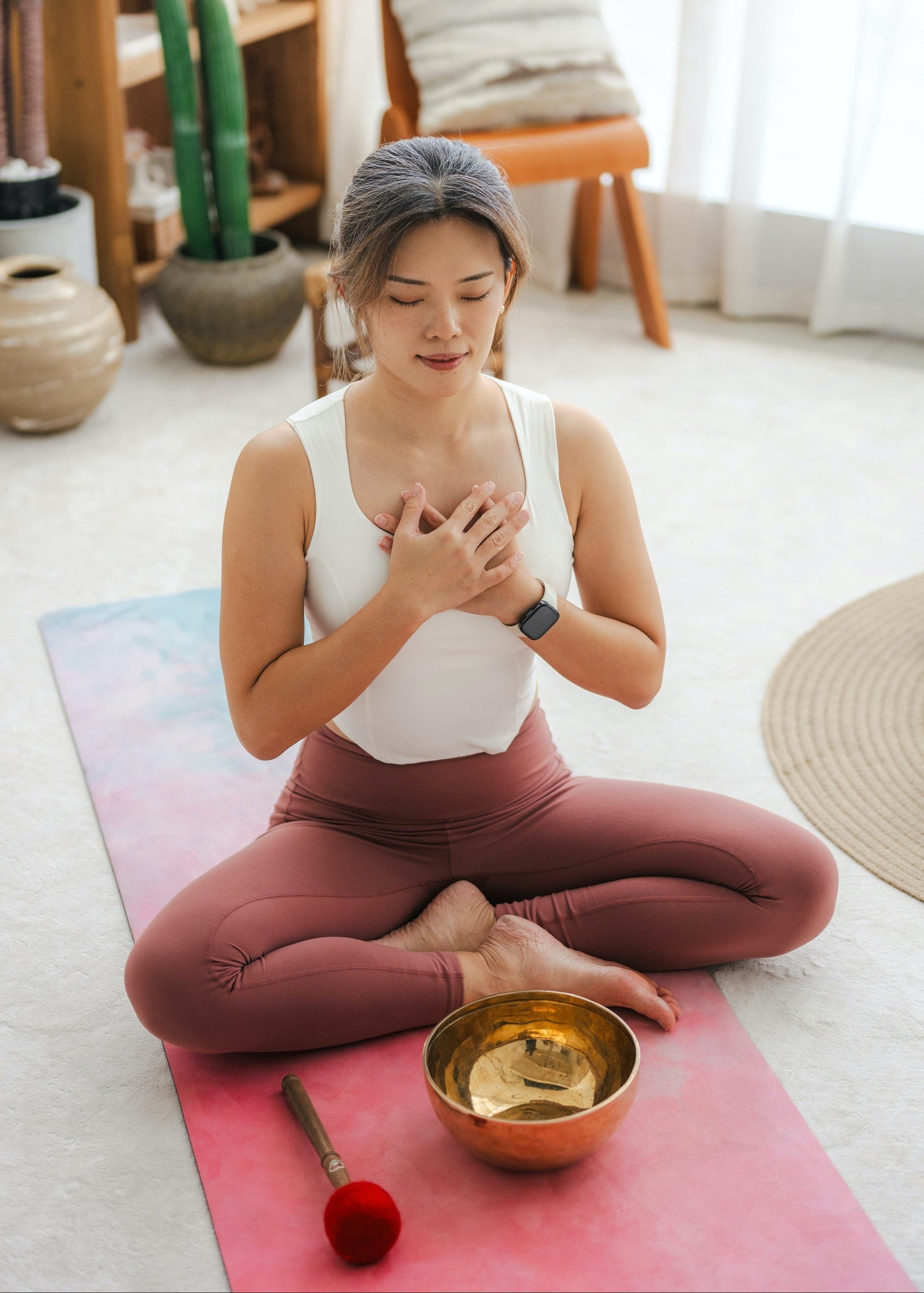 Woman meditating with Serene Streams Tibetan singing bowls, inspired by centuries of Himalayan craft tradition