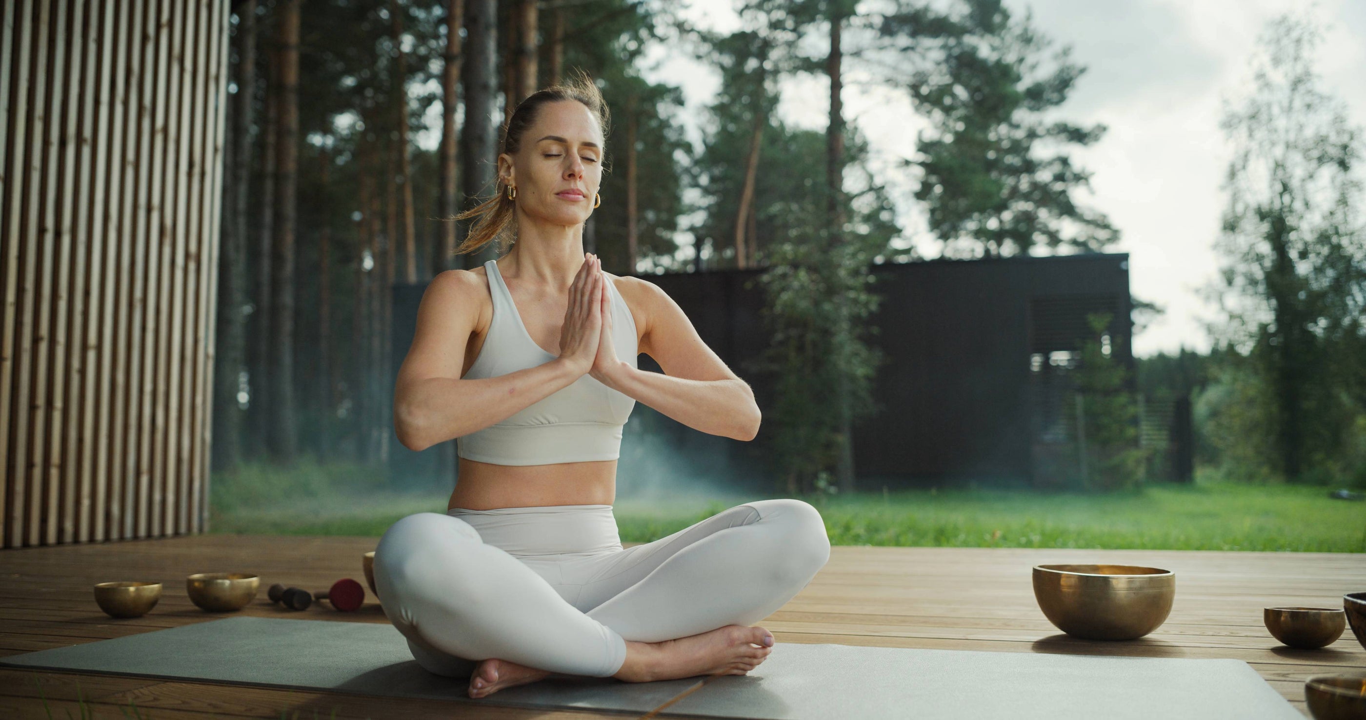 Girl meditating in a tranquil outdoor setting with Serene Streams Tibetan singing bowls, drawing forward deep inner peace