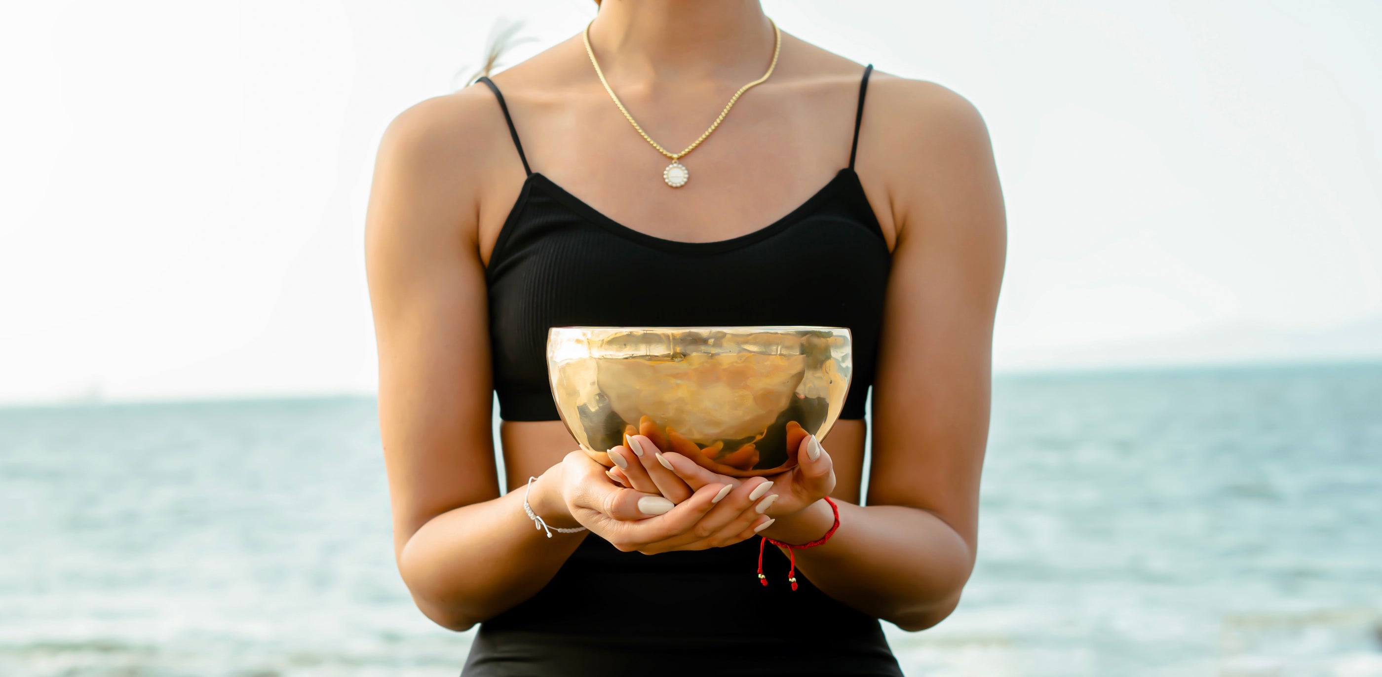 Woman holding a Serene Streams Tibetan singing bowl outdoors, handcrafted by master artisans in Kathmandu Nepal